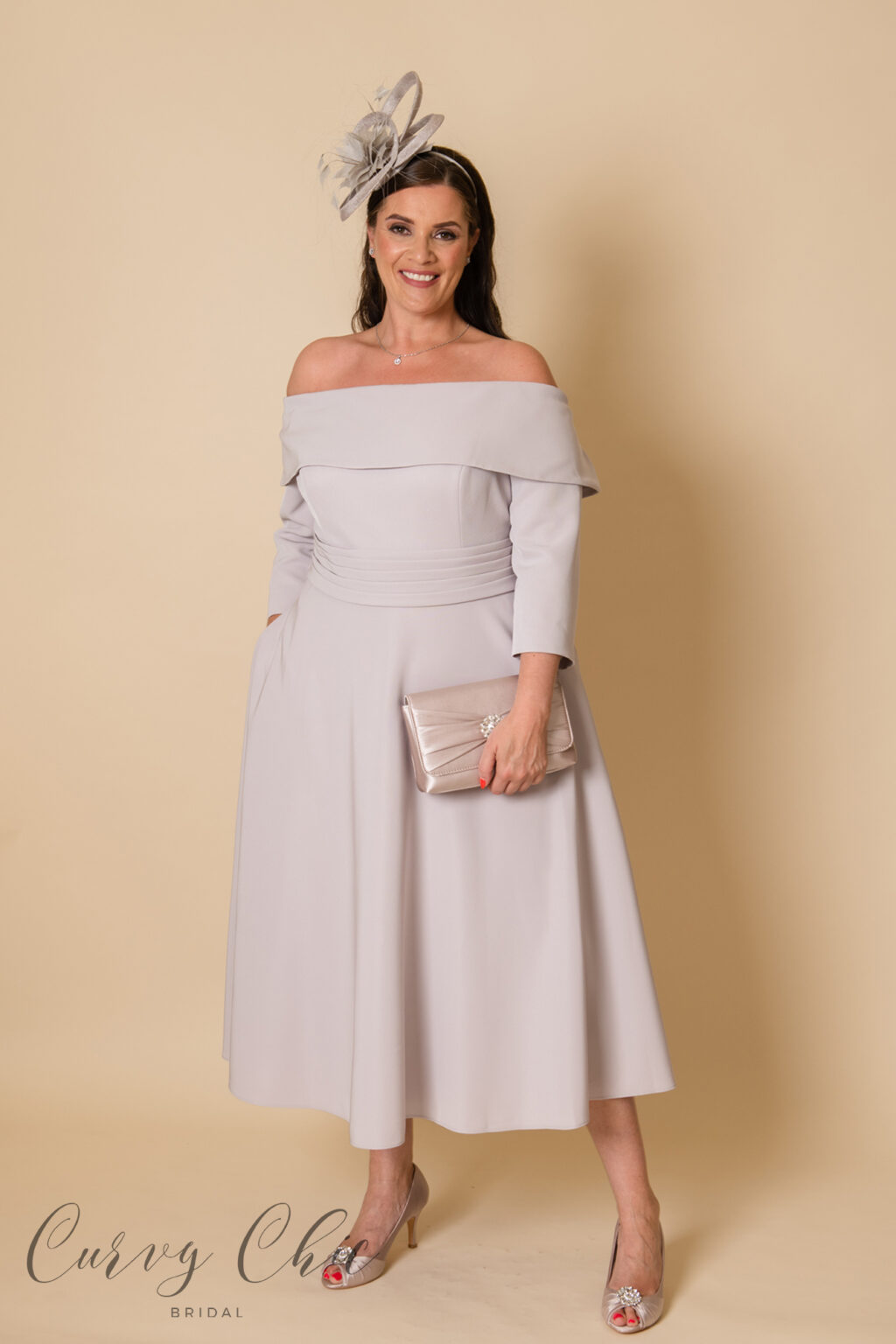 29668C-T plus size mother of the bride off the shoulder style midi length dress in taupe with pockets and bow detail